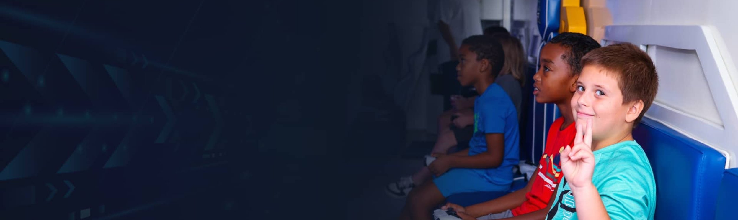 Smiling boy giving peace sign in gaming trailer